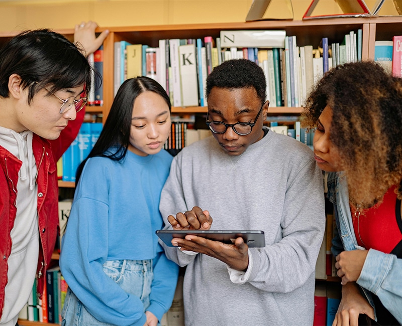 Students in a Library Looking at a Tablet Screen searching for Mental Health Definitions