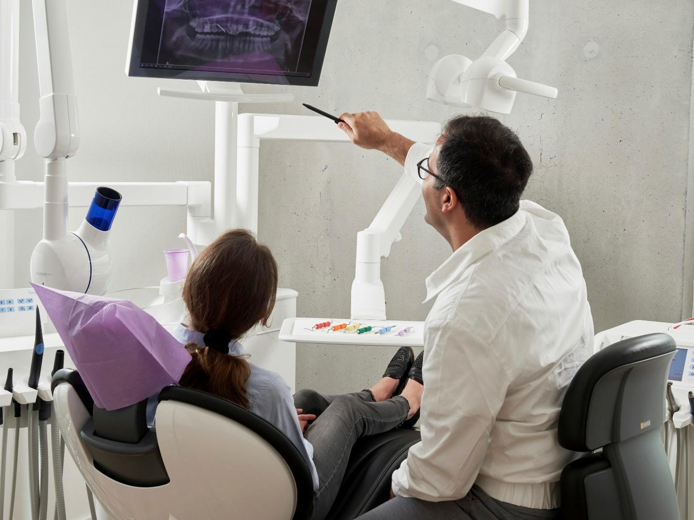 Dentist discussing a dental X-ray with a patient